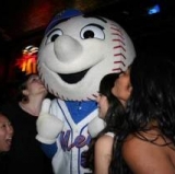 Mr Met gets to first base safely.